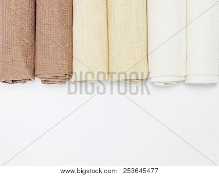 Multicolored Clean Towels On A White Background Top View With Copy Space. Texture Of Cotton, Waffle 
