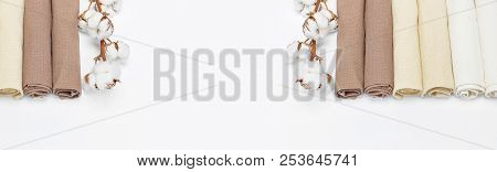 Multicolored Clean Towels With A Branch Of Cotton On A White Background Top View With Copy Space. Te