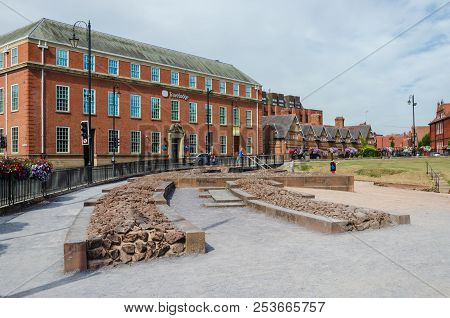 Chester, Uk: Aug 6, 2018: A Travelodge Hotel Is Directly Opposite The Remains Of A Roman Amphitheatr