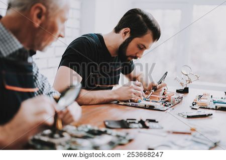 Two Men Repairing Hardware Equipment From Pc. Repair Shop. Worker With Tools. Computer Hardware. You