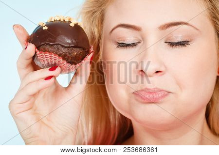 Diet, Sweets, Food Concept. Woman Holding Delicious Chocolate Cupcake With Peanut Frosting About To 