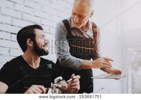 Two Men Repairing Hardware Equipment In Workshop. Repair Shop. Worker With Tools. Computer Hardware.