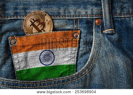 Golden Bitcoin (btc) Cryptocurrency In The Pocket Of Jeans With The Flag Of Republic Of India On Jea