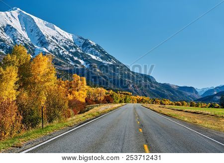 Highway in Colorado Rocky Mountains at autumn, USA. Mount Sopris landscape.
