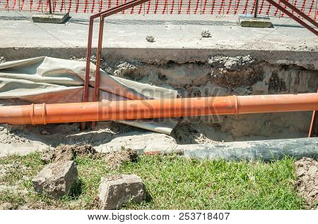 Open Trench On The Street Excavation Site With Visible Pipes For Water Gas And District Heating Pipe