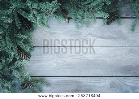 Christmas Firbranch With Cones On Old Wooden Rustic Background With Copy Space For Text, Toned