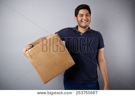 Delievery Young Man With Box Isolated On Gray Background