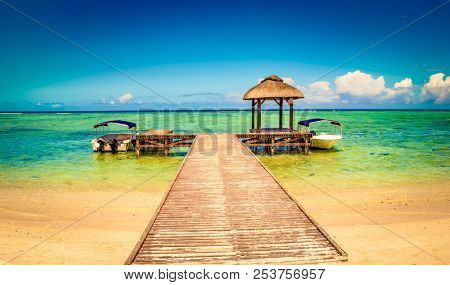 Sandy tropical Wolmar beach at sunny day. Jetty on the foreground. Beautiful landscape. Mauritius