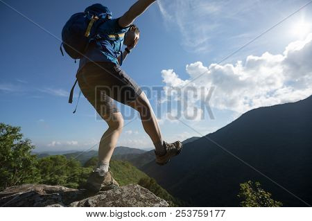 Woman Hiker Walking To The Cliff Edge On Mountain Top With Eyes Covered