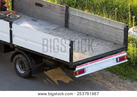 Close-up Detail Of Empty Hydraulic Truck Mounted Crane Body Parked On Green Grassy Roadside. Modern 