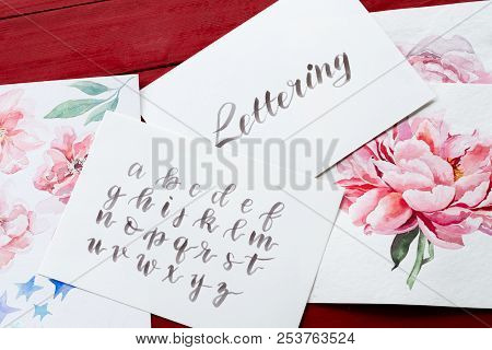 Lettering Art And Calligraphy Craft. Handwritten Italic Cursive. Drawn Alphabet And Watercolor Flora