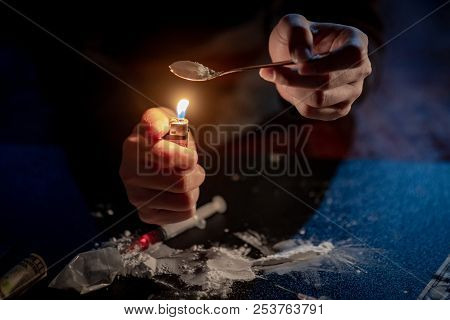 Male Junkie Hand Preparing Heroin Dose By Using Spoon And Cigarette Lighter For Melting, Syringe For