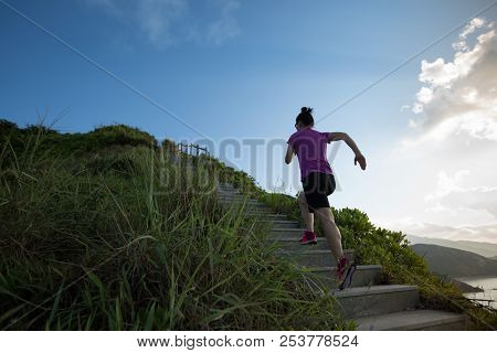 Woman Running Up On Seaside Mountain Stairs