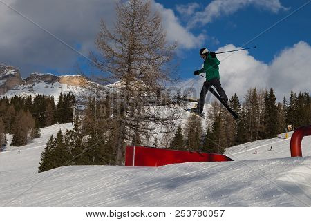 Skier In Action: Ski Jumping In The Mountain Snowpark.
