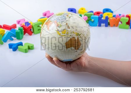 Little Model Gobe In Hand With Colorful Letters Behind
