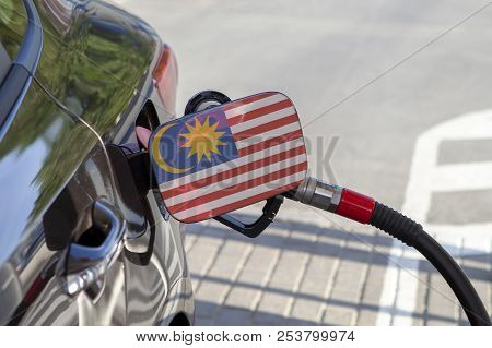 Fueling Car With Petrol Pump At A Gas Station.