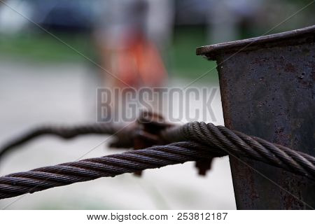 Thick Steel Rope Close Up. Bridge Fence Element. Detailed View. The Surface Of The Steel Cable Is Co