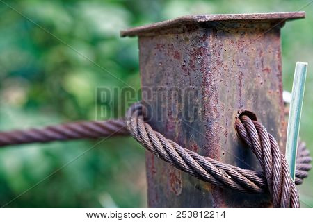Thick Steel Rope Close Up. Bridge Fence Element. Detailed View. The Surface Of The Steel Cable Is Co