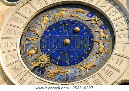 Ancient time, astrology and horoscope. Detail of Saint Mark Square old Clocktower with zodiac signs, planets and stars (15th century)