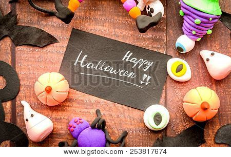 Halloween Concept. Symbols And Decorations Made Of Polymer Clay On Wooden Table Flat Lay Top View