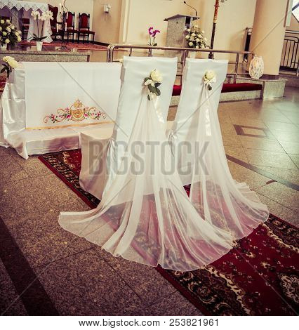 Chairs Set Up And Decorated For A Weeding In A Church