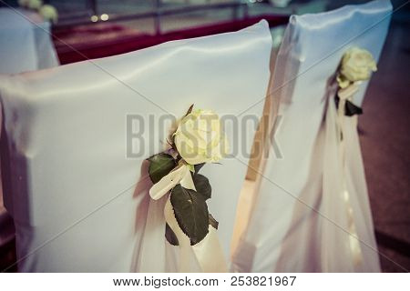Chairs Set Up And Decorated For A Weeding In A Church