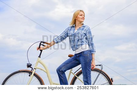 Active Leisure And Healthy Activity. Girl Ride Cruiser Model Bicycle. Woman Rides Bicycle Sky Backgr