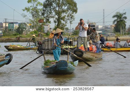 Phong Dien, Vietnam - December 31st 2017. A Tourist On A Boat Tour Takes Photos Of A Vendor At The P