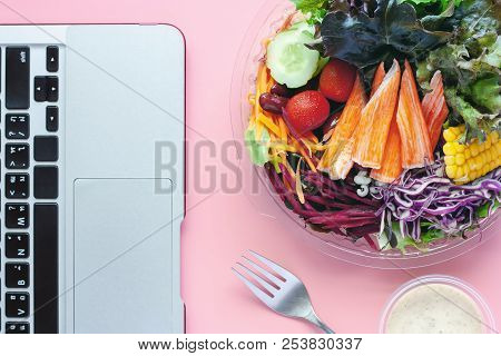 Fresh Salad Vegetables With Computer Laptop At Workplace For Diet And Heathy Lunch Eating Concept