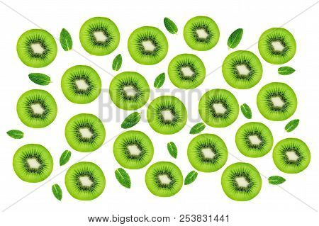 Creative Layout Made Of Kiwi Fruits Snd Mint Leaves. Many Slices Of Ripe And Juicy Kiwifruit. Flat L