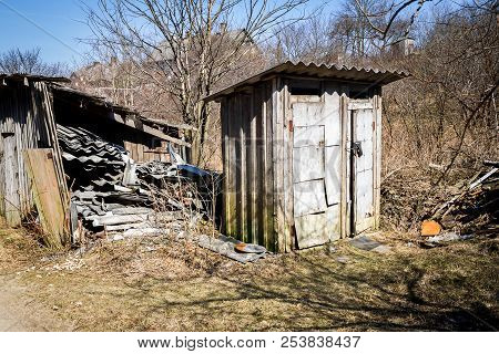 Double Outhouse Toilets In A Village. Rustic Old Wooden Toilets.