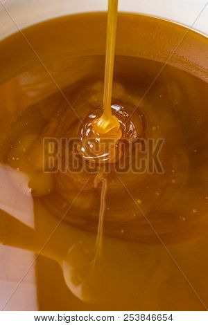 Honey Liquid Background Macro Closeup. Helth Food