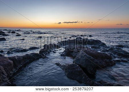 Sunrise At Palmasera Beach In Cala Gonone On The Italian Island Of Sardinia
