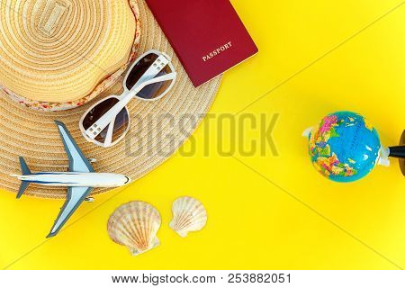 Flat Lay With Hat, Plane, Passport, Globe, Sunglasses And Shell On Yellow Colourful Trendy Modern Fa
