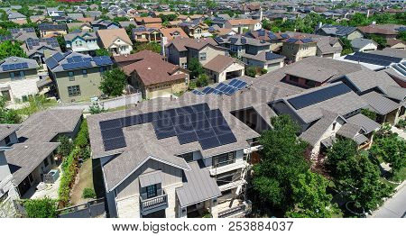 Facades And Hundreds Of Solar Panel Rooftops And Homes Wrapped Around Green Landscape In Mueller Dev