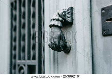 Close-up. Vintage Handle For Knocking On The Door In The Form Of A Hand. Entrance To The Apartment B