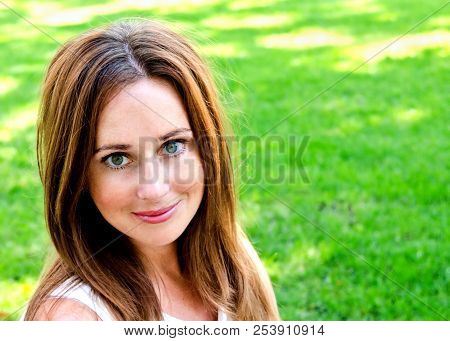 Portrait Of Prety Smiling Young Woman Outdoors In Summer Day