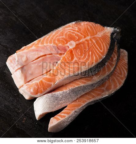 Raw Salmon Fish Fillet On Black Background