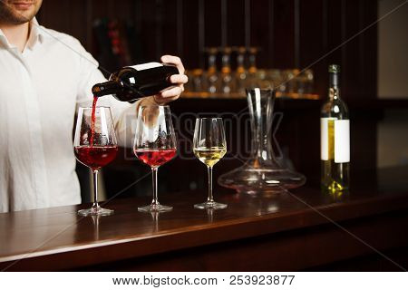 Sommelier Pouring Different Types Of Fine Wine