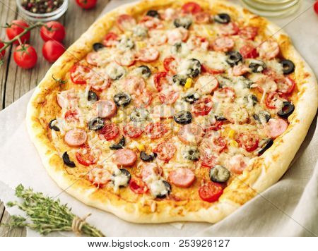 Homemade Lagge Pizza With Parmesan, Oregano, Olives And Mozzarella, Sausage And Tomato Sauce, Side V