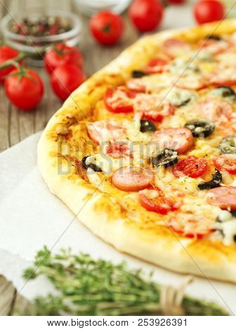 Part Of Homemade Lagge Pizza With Parmesan, Oregano, Olives And Mozzarella, Sausage And Tomato Sauce