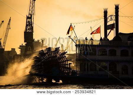 Steam paddle boat in Hamburk, Germany, with a backdrop of a lovely sunset