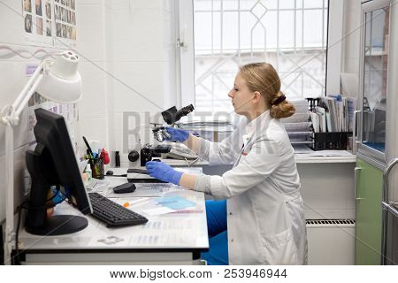 Doctor Woman Working With A Microscope In Laboratory. Female Scientist Looking Through A Microscope 