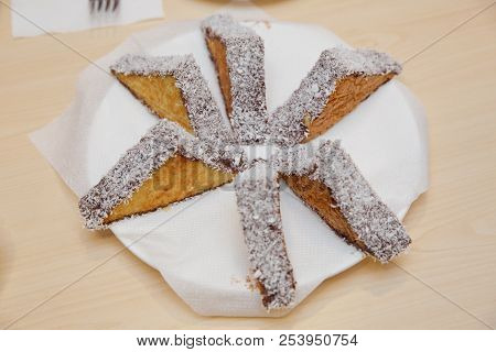 Three-pointed White Cake And Cake With Chocolate. Coconut Cake On White Plate. Cremeschnitte Cake On