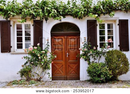 Close Up Of The Front A Historical House With Wild Wine
