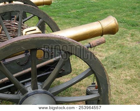 Artillery Gun Of The 19th Century On A Green Field. Old Smoothbore Cannon Outdoors