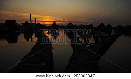 Floating village over lake at sunset.  Bokod, Hungary.