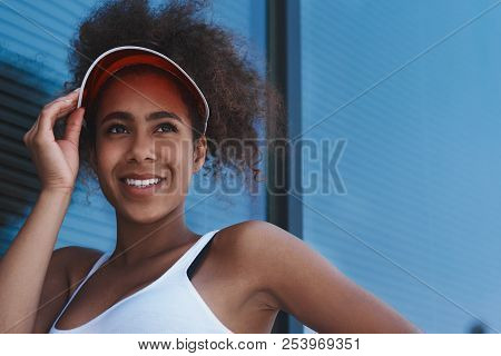 Young Woman In Visor Free Style On The Street Walking Near Windo