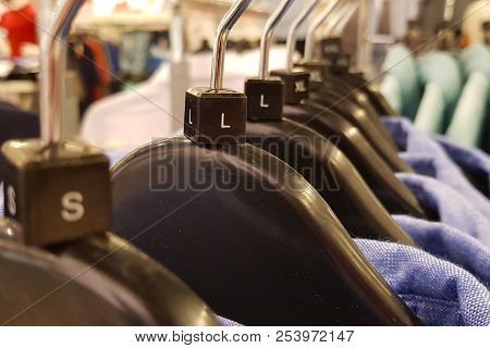 Men's Blue Colored Shirts On The Vases At The Retailer.