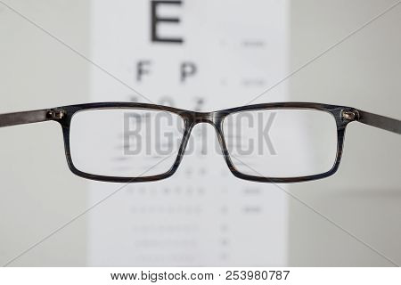 Close-up Of Eyeglasses For Vision, Pointing At Table To Check View. The Concept Of Poor Vision, Blin